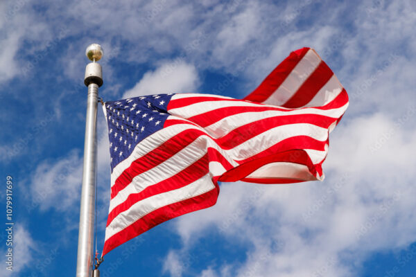 American flag waving against a blue sky